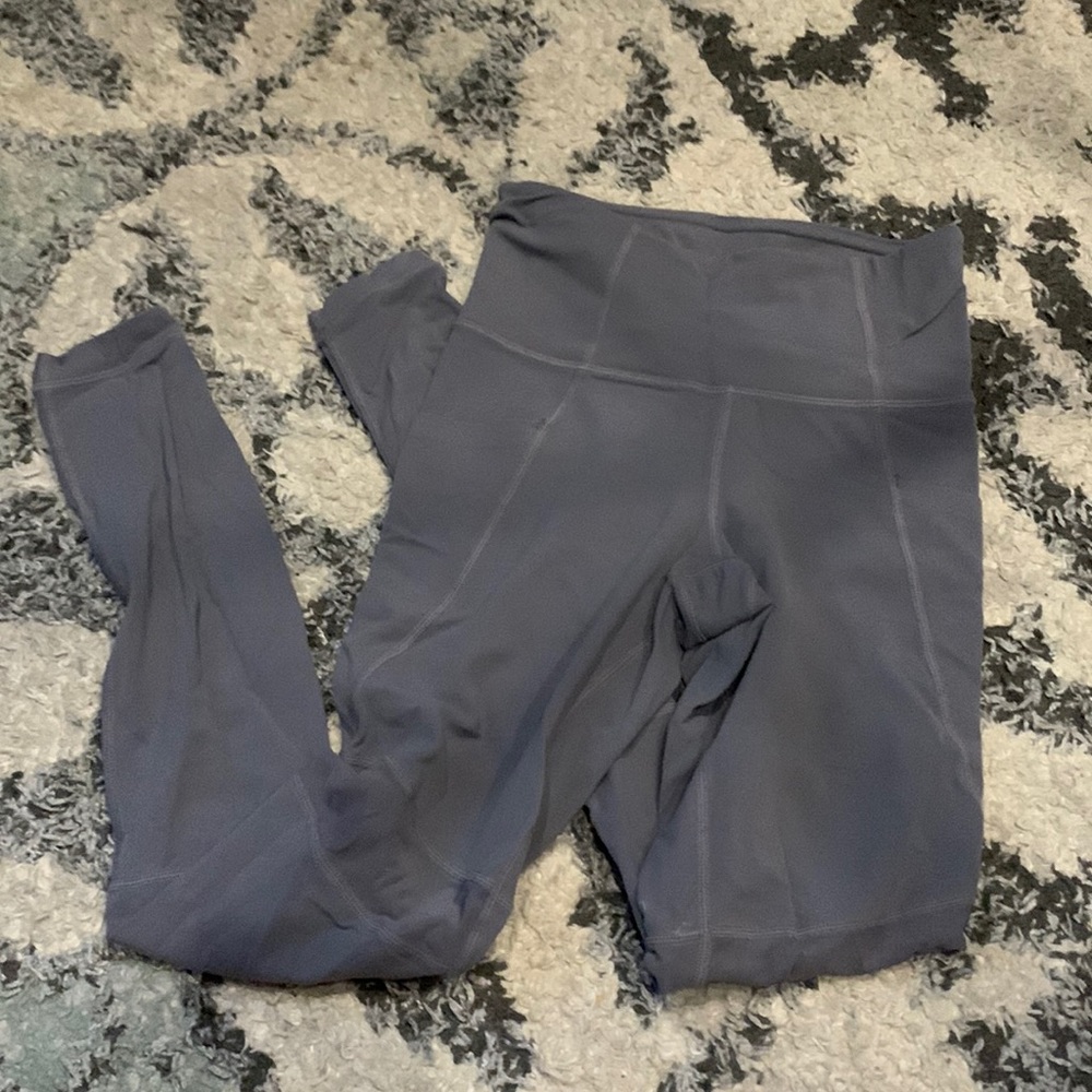Grey leggings with mesh on bottom and pockets on side